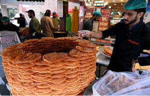 Vendor displaying traditional sweet item (Jalebi) for iftar at Karachi Company during Holy month of Ramadan in the Federal Capital