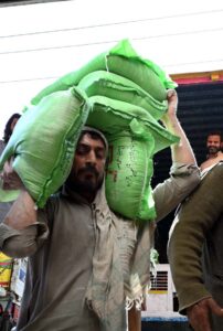 A person carrying flour bags provided by the Government on subsidized rate.