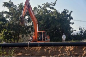 Labourer installing underground main Gas Pipe line with the help of heavy machinery at G-9 Peshawar More.