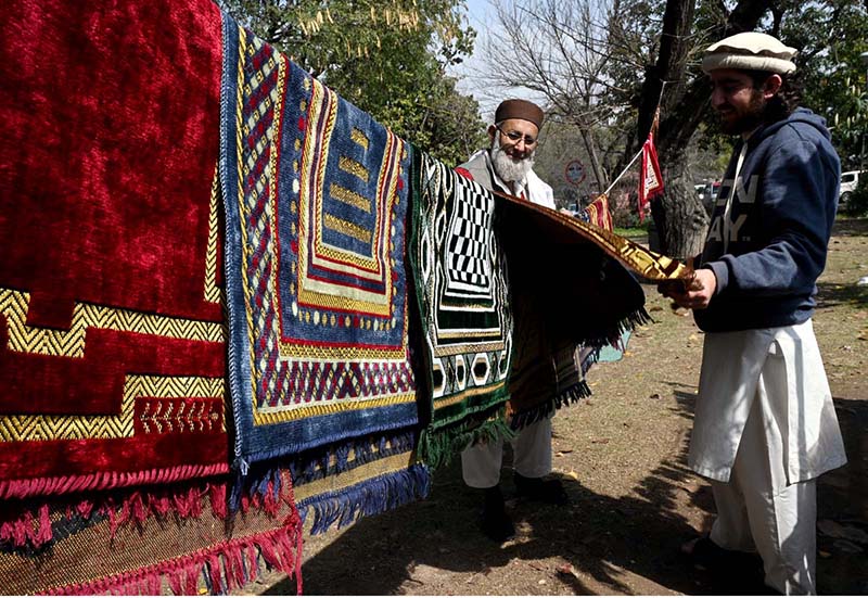 A vendor displaying and selling Prayer mats to attract customers at Aabpara in the Federal Capital