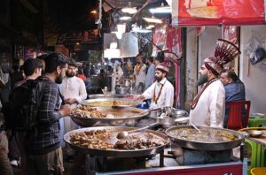 Customers purchasing edible stuffs for Sehri from a market at Kartarpura area in the city.