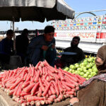 A labourer loading sack of potatoes on a delivery truck at Fruit and Vegetable Market