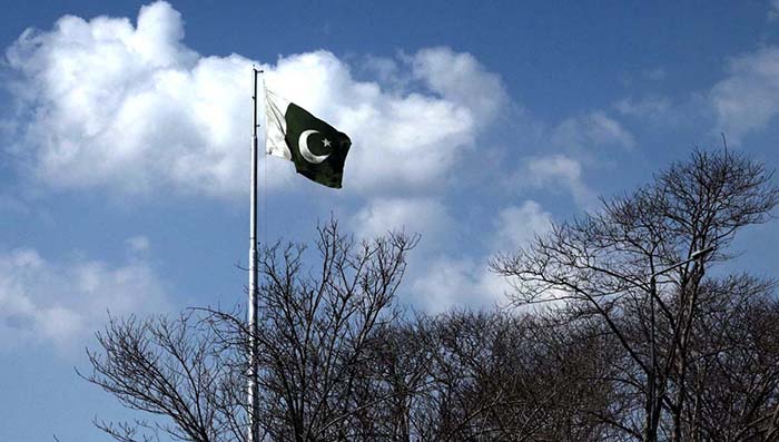 A beautiful view of national flag flying as in the background an attractive view of clouds hovering over the skies of Federal Capital.