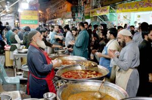 Customers purchasing edible stuffs for Sehri from a market at Kartarpura area in the city.