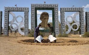 CDA gardeners spreading fertilizer for planting saplings at roadside greenbelt in Federal Capital.