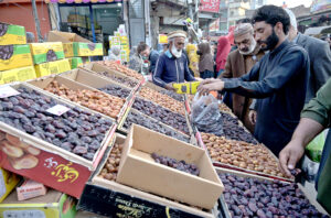 Customers busy in purchasing dates for Iftar during the holy month if Ramazan at Raja Bazaar market.