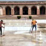 Workers cleaning floor at Lahore Fort
