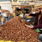 A vendor selling dates during holy fasting month of Ramadan at sasta Ramzan Bazar Abpara in the Federal Capital
