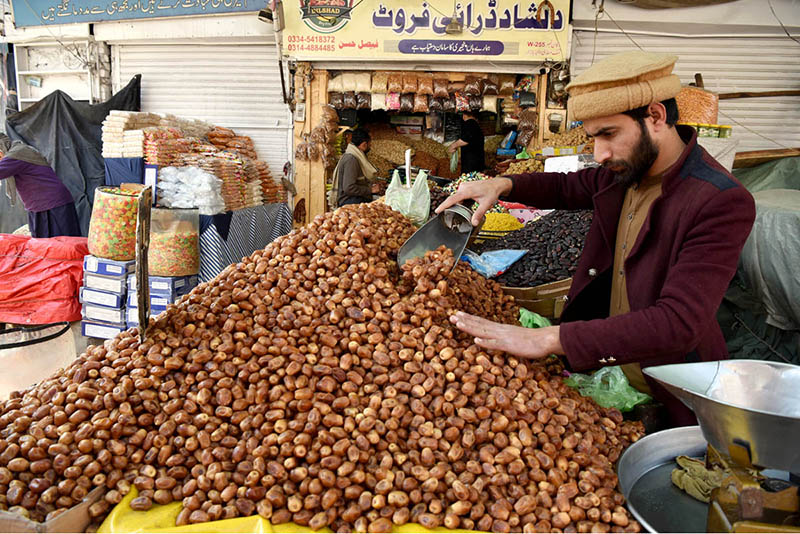 A vendor selling dates during holy fasting month of Ramadan at sasta Ramzan Bazar Abpara in the Federal Capital