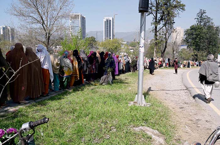 A large number of women standing in a queue to draw money from Benazir Income Support Programme (BISP) beneficiaries outside Benazir One Window Center at G-7.