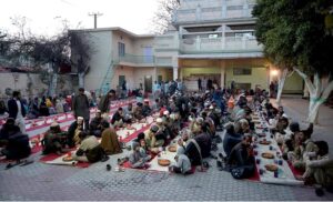 Volunteers serving iftar for deserving people at Eidgah Sharif.