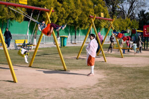 Children enjoy swings in a local Park