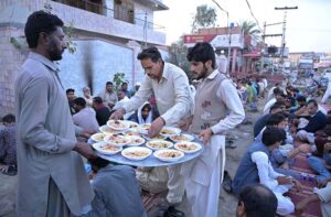 Volunteers of Imran Motors preparing sweet drinks for Iftar at Khayam Chowk.