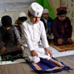Students of Private School offering Prayer during School Motivated Activity of Holy Fasting Month of Ramadan at Dosehra Ground