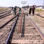 Railway workers moving the rail tracks near railway station