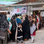 A large number of Women in a queue to get flour on Government subsidized rate from utility store