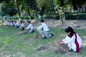 Students planting tree saplings during the International Forest Day arranged by Parks and Horticulture Authority at Bagh-e-Jinnah.