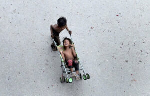 Gypsy children playing outside their makeshift camp under the flyover.