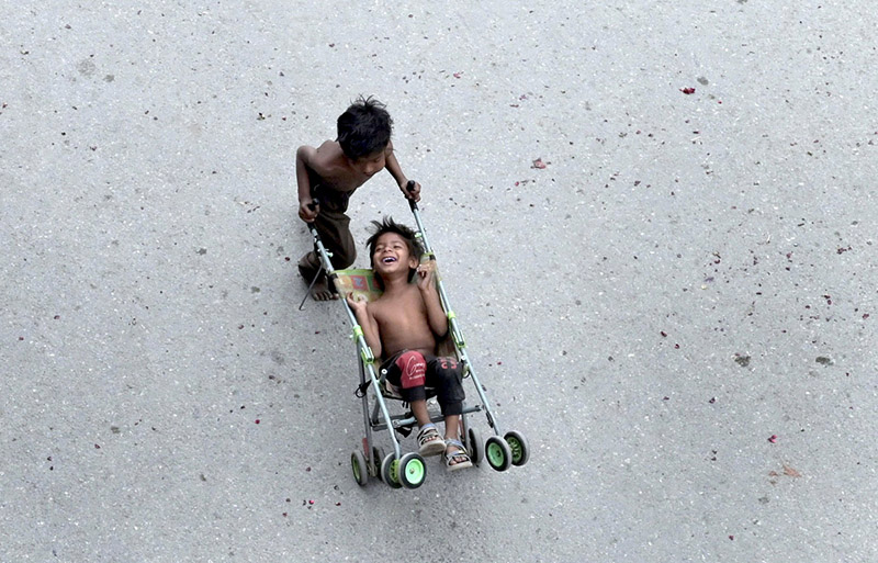 Gypsy children playing outside their makeshift camp under the flyover.