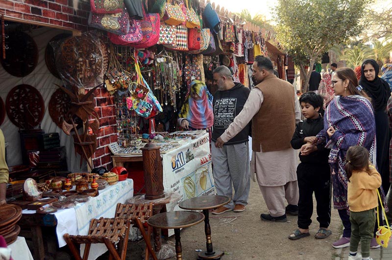 A vendor displaying clay-made and wooden items to attract customers at his setup in the city