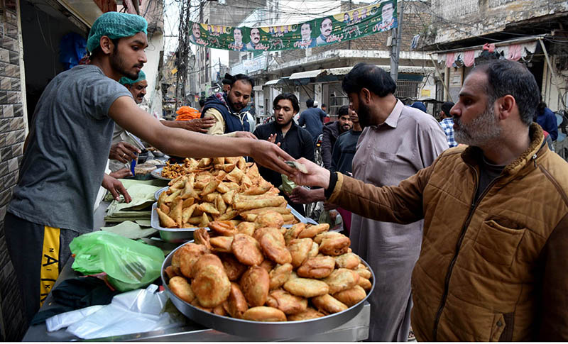 People purchasing traditional food items for iftar during Holy fasting month of Ramadan.