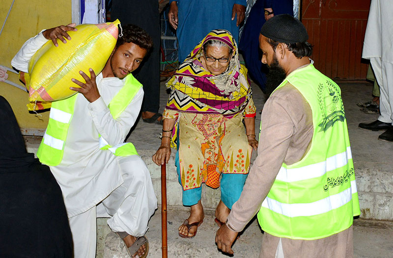 Volunteers distribution ration bags to deserving people donate by jilani welfare foundation during Holy fasting month of Ramadan at Latifabad.