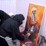 Student giving final touch to painting during Punjab painting competitions organized by Sargodha Arts Council