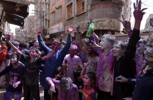 Hindu girls celebrates religious ritual Holi, the Spring Festival of Colors at Durgah Shiva Mandir.