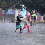 Students on the way at University of Sargodha during rain that experienced the city