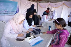 Student giving final touch to painting during Punjab painting competitions organized by Sargodha Arts Council