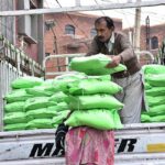 Workers off-loading Prime Minister Ramadan Relief Package Flour Bags at a Utility Store on Eid Gah Road.