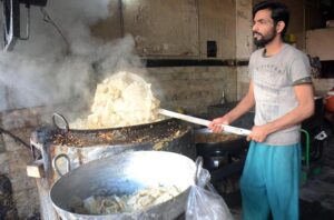 A vendor busy frying traditional food item (Samosa) for Iftar during Holy Fasting Month of Ramadan at Muslim Bazar.