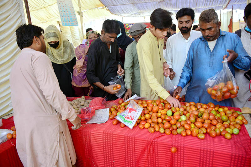 People purchasing vegetables from Ramzan Bachat Bazar organized by local government during Holy month of Ramadan at Shaheed-E-Millat Park