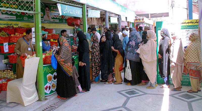 Women standing in a queue to purchase fruits and vegetables on subsidized rates at Ramadan Model Bazar