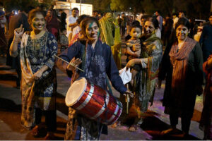 Hindu girls celebrates religious ritual Holi, the Spring Festival of Colors at Durgah Shiva Mandir.