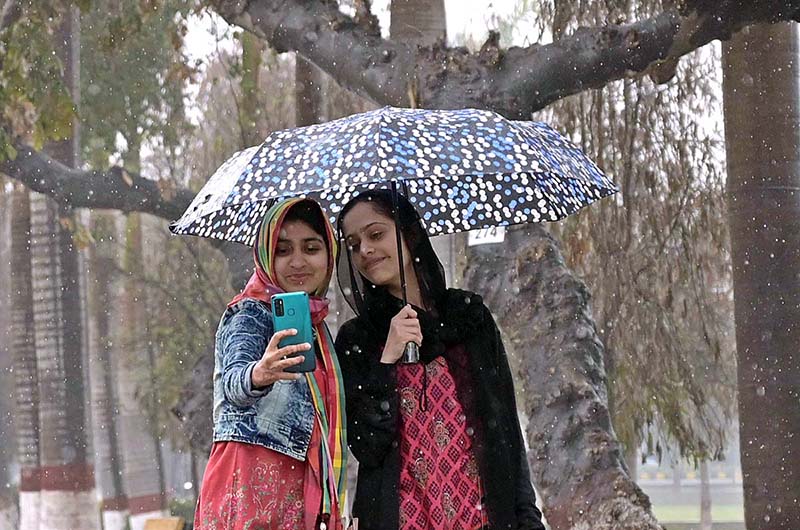 Students on the way at University of Sargodha during rain that experienced the city