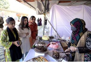 Student giving final touch to painting during Punjab painting competitions organized by Sargodha Arts Council