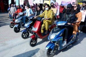 Students participating in scooty march and walk to mark International Women's Day at Government College for Women University (GCWUF) Madina Town.
