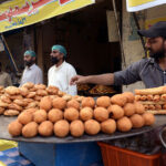 Vendors displaying samosas, kachoris, and chicken rolls to attract customers for iftari during Holy fasting month of Ramzan.