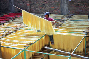 Workers busy in packing vermicelli after preparing vermicelli as per increased demand of customers to be used at upcoming Eid-ul-Fitr festival