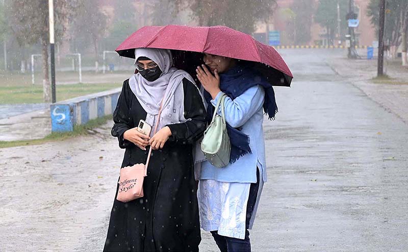 Students on the way at University of Sargodha during rain that experienced the city