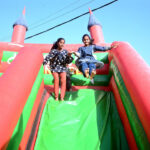 Children having fun on a slide in a public park.