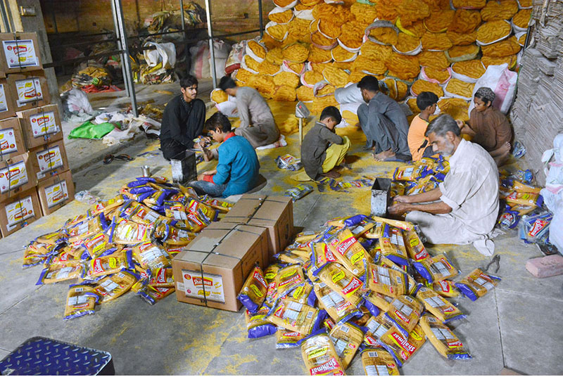 Workers busy in packing vermicelli after preparing vermicelli as per increased demand of customers to be used at upcoming Eid-ul-Fitr festival