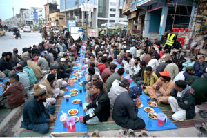 People offering Dua before Iftar arranged by an NGO at Ghouri Town.