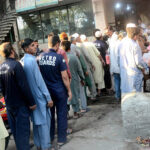A large number of people standing in a queue to get free iftaar during Holy fasting Month of Ramadan