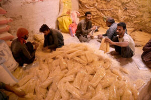 A worker busy hanging sawaiyan (vermicelli) for drying purpose in the sunlight at local factory.
