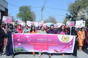 Students participating in scooty march and walk to mark International Women's Day at Government College for Women University (GCWUF) Madina Town.
