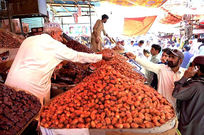 People selecting and purchasing the dates ahead of the holy fasting month of Ramadan at Tower market.