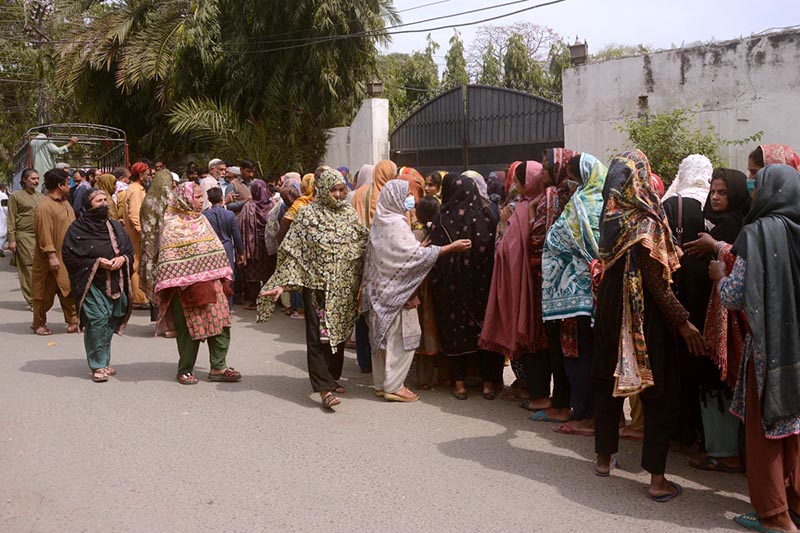 A large number of women in a queue to get flour bag on subsidies rate