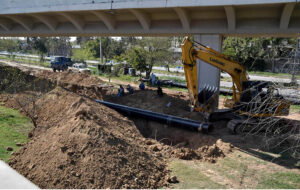 Labourer busy Installing underground main Gas pipe line with the help of crane at G-9 Peshawar More.